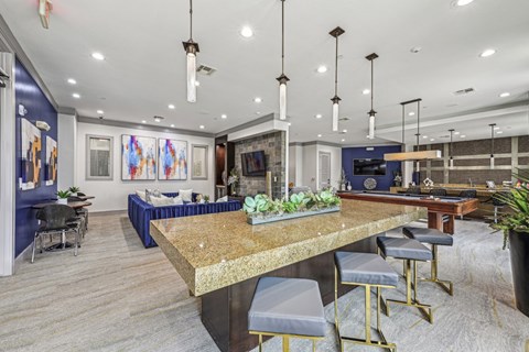 Spacious resident lounge with comfortable seating and vibrant artwork at Allusion at West University apartments in Houston, TX
